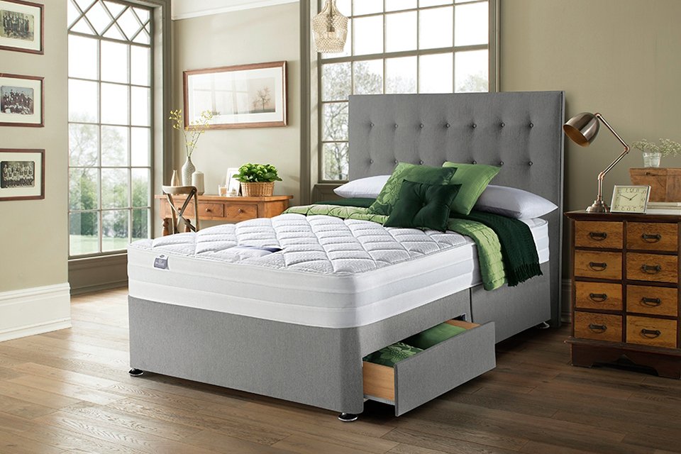 Silentnight Knightly Double Memory 2 Drawer Divan Bed in grey colour placed in a bedroom.